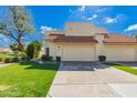 Home's garage and driveway with beautiful landscaping and a tile roof at 13375 N 96Th Pl, Scottsdale, AZ 85260
