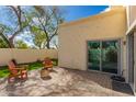 The home's back patio includes chairs, a fire pit, and sliding glass doors at 13375 N 96Th Pl, Scottsdale, AZ 85260