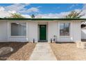 Close-up of a charming front door with green paint and sidelights at 16810 N 65Th Pl, Scottsdale, AZ 85254