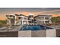 Impressive modern home with pool, waterfall feature, lounge area, and multi-level balconies at 16856 N Mountain Pkwy, Fountain Hills, AZ 85268