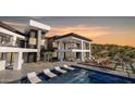 Stunning modern home featuring a private pool, outdoor lounge, and sleek architectural design at 16856 N Mountain Pkwy, Fountain Hills, AZ 85268