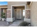 A welcoming front porch with stone accents and a stylish security door at 2561 E Toledo Ct, Gilbert, AZ 85295