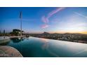 Breathtaking infinity pool with a view of the mountains and American Flag at 3168 S Yaqui Ln, Gold Canyon, AZ 85118