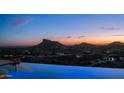 Gorgeous twilight view of the infinity pool showcasing scenic mountain views at 3168 S Yaqui Ln, Gold Canyon, AZ 85118