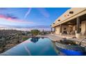Stunning outdoor space showcasing a luxurious infinity pool and spa overlooking the scenic landscape at 3168 S Yaqui Ln, Gold Canyon, AZ 85118