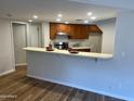 Charming kitchen featuring wood cabinets, stainless steel appliances, and a breakfast bar at 3228 W Glendale Ave # 103, Phoenix, AZ 85051