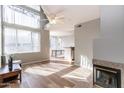 Bright living room features hardwood floors, fireplace and abundant natural light through large windows at 3633 N 3Rd Ave # 2016, Phoenix, AZ 85013