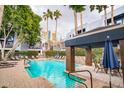 Resort-style pool area with comfortable lounge chairs, lush landscaping, and serene waterfall feature at 3633 N 3Rd Ave # 2016, Phoenix, AZ 85013