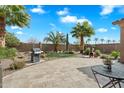 Spacious backyard features a built-in putting green, paver patio, barbecue, and desert landscaping at 4021 S Tumbleweed Ct, Chandler, AZ 85248