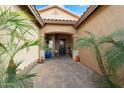 Inviting front entrance featuring a beautiful, decorated door and stone-paved walkway, framed by lush palms at 4021 S Tumbleweed Ct, Chandler, AZ 85248