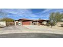 Charming home with stone accents, a tile roof, wooden gate, and a spacious driveway at 4116 E Sierra Sunset Trl, Cave Creek, AZ 85331