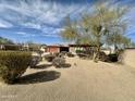 Expansive front yard featuring desert landscaping and mature trees, complementing the home's exterior at 4116 E Sierra Sunset Trl, Cave Creek, AZ 85331