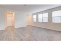 Bright living room featuring vinyl flooring, white walls and multiple windows for natural light at 4240 W Crossflower Ave, San Tan Valley, AZ 85144