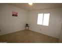 Bright, neutral bedroom with tile flooring and natural light at 4409 E Wood St, Phoenix, AZ 85040