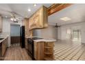 Bright kitchen featuring wood cabinetry, a central island, and seamless flow to the living spaces at 4837 E Avalon Dr, Phoenix, AZ 85018