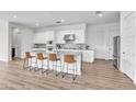 Bright kitchen features an island with seating and ample counter space, perfect for entertaining at 5611 S Feliz --, Mesa, AZ 85212