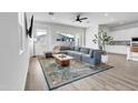 Open concept living room with modern décor, large windows, and a comfortable sectional sofa at 5611 S Feliz --, Mesa, AZ 85212
