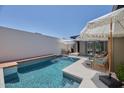 Enclosed backyard pool with a lounge area, white brick privacy wall, and blue tile accents at 6649 N Majorca E Ln, Phoenix, AZ 85016