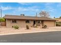 Well-maintained single-story brick home with desert landscaping and a two car garage at 6917 E Flossmoor Ave, Mesa, AZ 85208