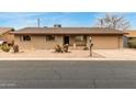 Charming single-story brick home with a two car garage and desert landscaping at 6917 E Flossmoor Ave, Mesa, AZ 85208