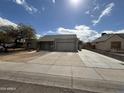 Single-story home with long driveway and desert landscaping in front yard at 7033 W Sunnyside Dr, Peoria, AZ 85345