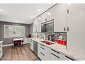 Modern kitchen with white cabinets, stainless steel appliances, and a stylish backsplash at 10453 W White Mountain Rd, Sun City, AZ 85351