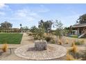 Lush backyard with a water feature, sprawling green space, and mature trees for ultimate privacy at 11601 N 85Th St, Scottsdale, AZ 85260