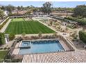 Aerial view of a backyard with a pool, putting green, playground, and plenty of space for fun at 11601 N 85Th St, Scottsdale, AZ 85260