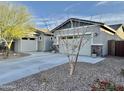 Charming single story home with stone accents, a two-car garage, long driveways and desert landscaping at 12519 W Oyer Ln, Peoria, AZ 85383