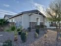 Charming single story home with stone accents, desert landscaping and views of blue sky at 12519 W Oyer Ln, Peoria, AZ 85383