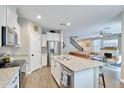 Bright kitchen featuring white cabinets, stainless steel appliances, granite countertops and an eat-in island at 1255 N Arizona Ave # 1148, Chandler, AZ 85225