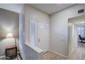 Bright entryway featuring wood floors and a white front door at 16118 W Vista North Dr, Sun City West, AZ 85375