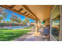 Spacious covered patio with scenic views of the pool and beautifully landscaped backyard at 16402 N 48Th Way, Scottsdale, AZ 85254