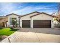 Charming single-story home with a well-manicured lawn, inviting curb appeal, and a two-car garage at 1737 E Marquette Dr, Gilbert, AZ 85234