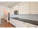 Well-designed kitchen featuring stainless steel appliances, dark granite counters, and white marble backsplash at 1777 E Dubois Ave, Gilbert, AZ 85298