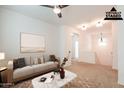 Upstairs living room featuring neutral tones, a ceiling fan, and a cozy seating area at 1777 E Dubois Ave, Gilbert, AZ 85298