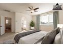 Spacious main bedroom with an ensuite bathroom featuring double doors and a large window at 1777 E Dubois Ave, Gilbert, AZ 85298