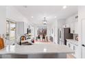 Bright kitchen with white cabinets, stainless appliances, and a dining area with a view at 1993 S Spartan St, Gilbert, AZ 85233