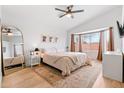 Cozy main bedroom featuring a ceiling fan, bay window, and warm decor at 1993 S Spartan St, Gilbert, AZ 85233