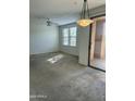 Bright bedroom featuring a ceiling fan, large windows, and access to balcony at 20100 N 78Th Pl # 1007, Scottsdale, AZ 85255