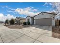 Single-story home featuring a two-car garage and easy-care desert landscaping at 20183 W Monroe St, Buckeye, AZ 85326