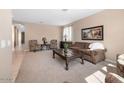 Spacious living room with plush carpet, neutral tones, and traditional furnishings at 20742 E Mockingbird Dr, Queen Creek, AZ 85142