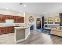 Inviting living room features a fireplace, wood floors, and view to the kitchen at 20750 N 87Th St # 1137, Scottsdale, AZ 85255