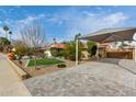 Spacious paved driveway with a covered parking area and meticulously landscaped front yard at 212 W Interlacken Dr, Phoenix, AZ 85023