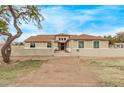 Charming single-story home features a well-manicured yard and neutral colored exterior at 21520 W Watkins St, Buckeye, AZ 85326