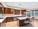 Gourmet kitchen featuring stainless steel appliances, a large island, and rich wood cabinetry at 21798 N Ingram Ct, Maricopa, AZ 85138