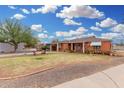 Single-story brick home with a well-kept lawn, covered porch, and inviting landscaping at 2230 N 14Th Pl, Phoenix, AZ 85006