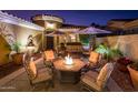 Stunning courtyard featuring a fountain, desert landscaping, and a fire pit with outdoor seating at 23236 N Caleta Ct, Sun City West, AZ 85375