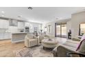 Bright open-plan living room with stylish furniture and seamless access to dining and kitchen areas at 29304 N Horton Creek Trl, Rio Verde, AZ 85263