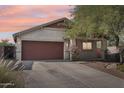 Charming home exterior with a two-car garage and a well-maintained yard, offering curb appeal at 30480 N 128Th Ln, Peoria, AZ 85383